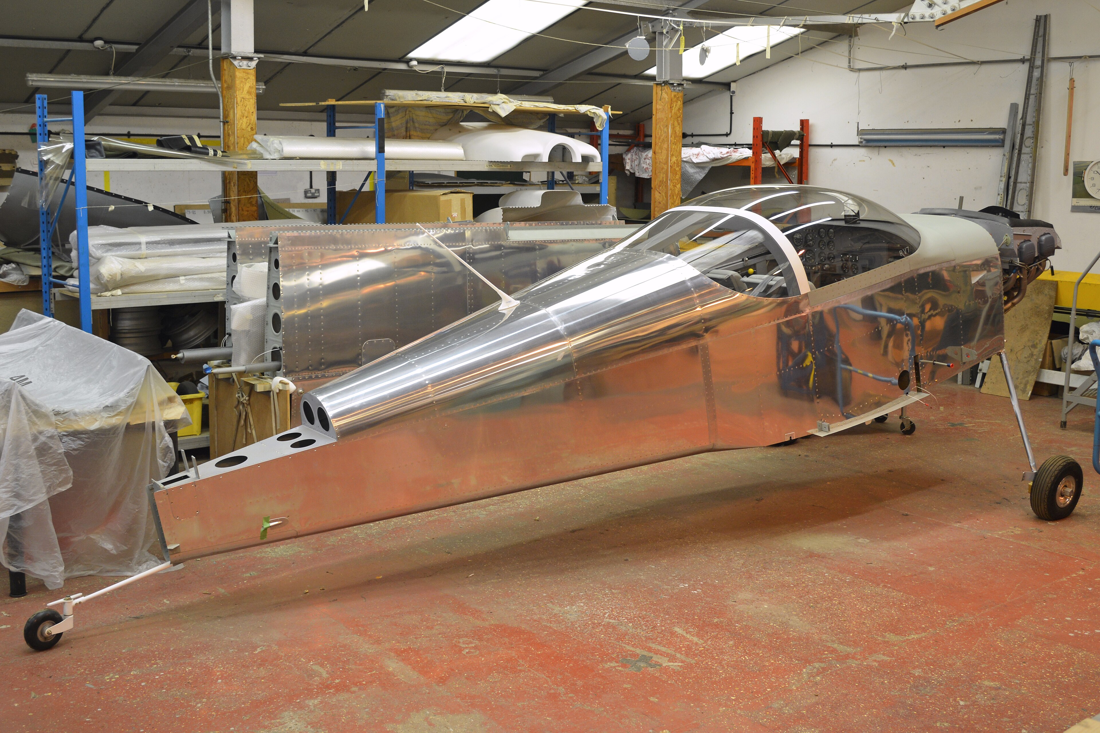 A Van's RV-7 fuselage in the workshop at Old Warden, Bedfordshire, May 2017, its bare aluminum skins closed with rows of flush rivets. Photo: Alan Wilson, CC BY-SA 2.0, via Wikimedia Commons.