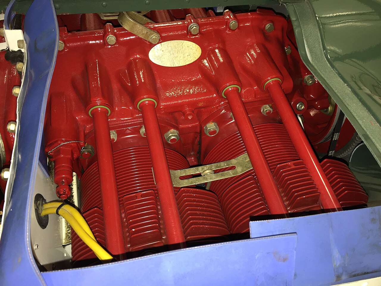 A Lycoming O-360 installed in a Grumman Tiger, with the cowling off: the crankcase, the pushrod tubes and the finned cylinders an engine heater warms. Photo: Clangenf, CC BY-SA 4.0, via Wikimedia Commons.